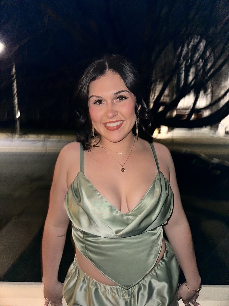 Magen in a sage satin cowl-neck gown, evening portrait