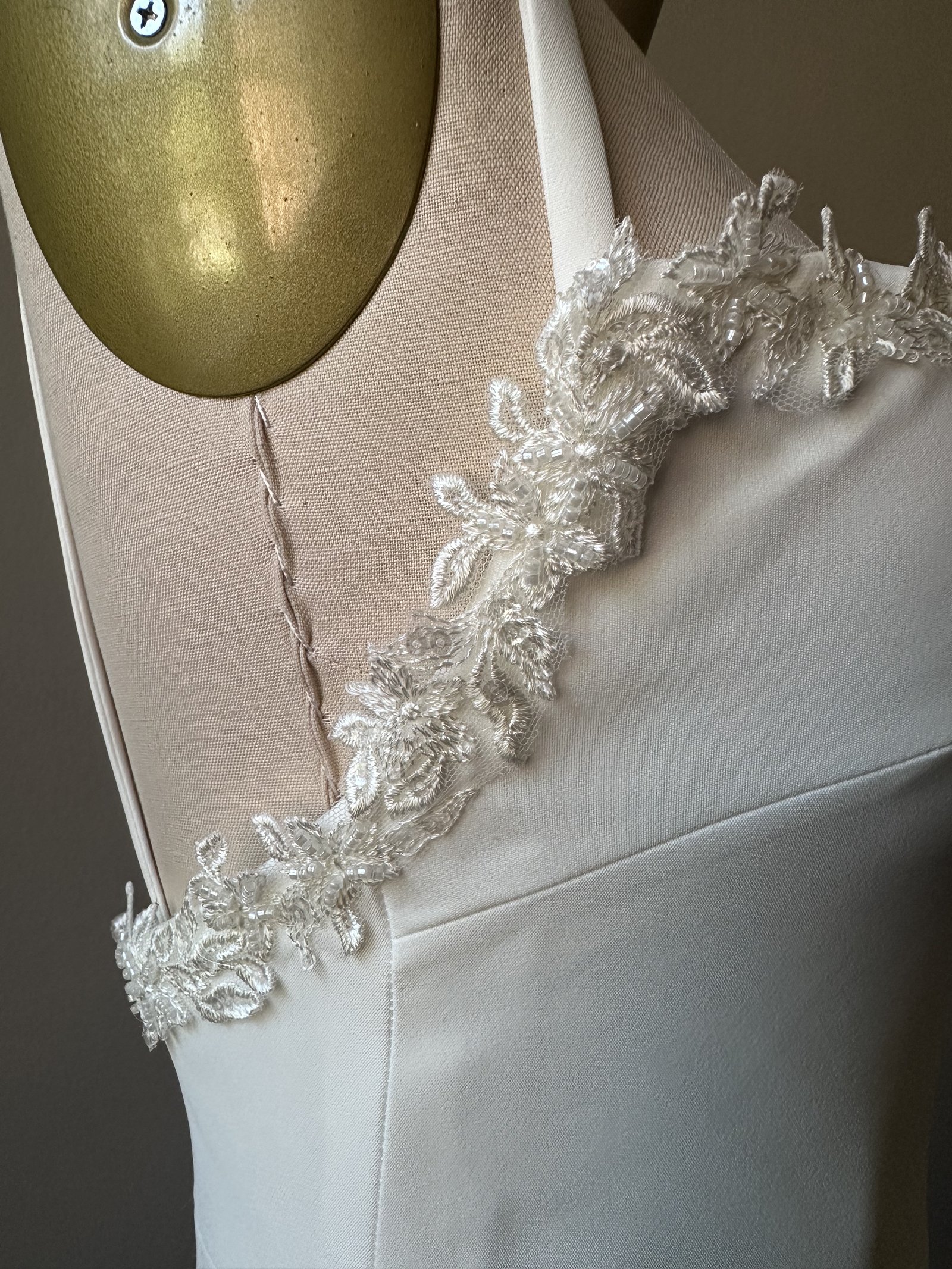 Beaded lace strap detail on a wedding gown