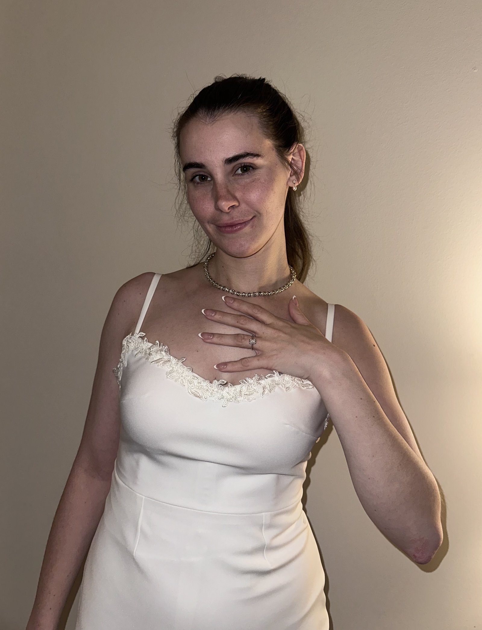 Ivory crepe gown with delicate lace neckline detail, portrait