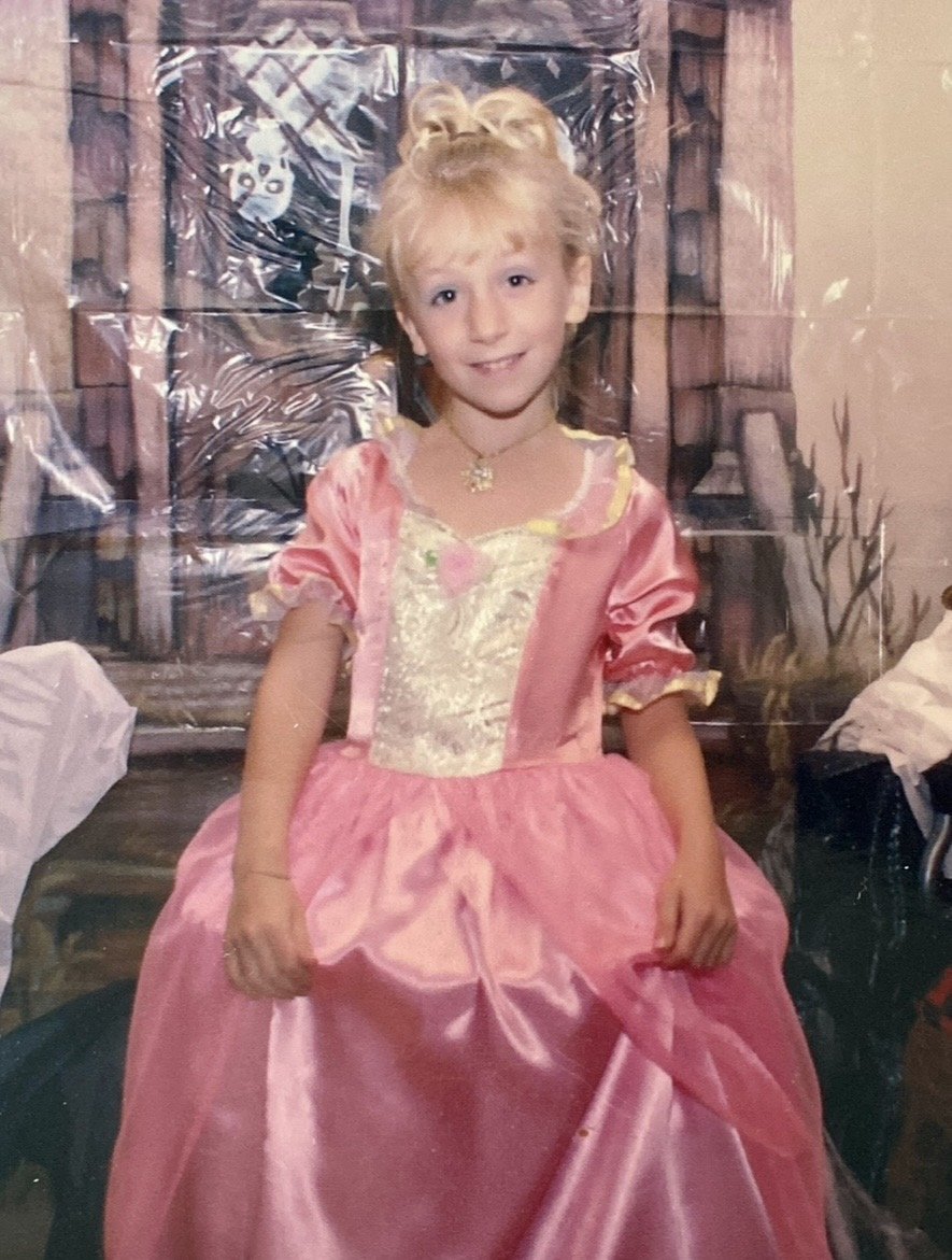 A young Magen in a pink princess gown — the spark of a designer