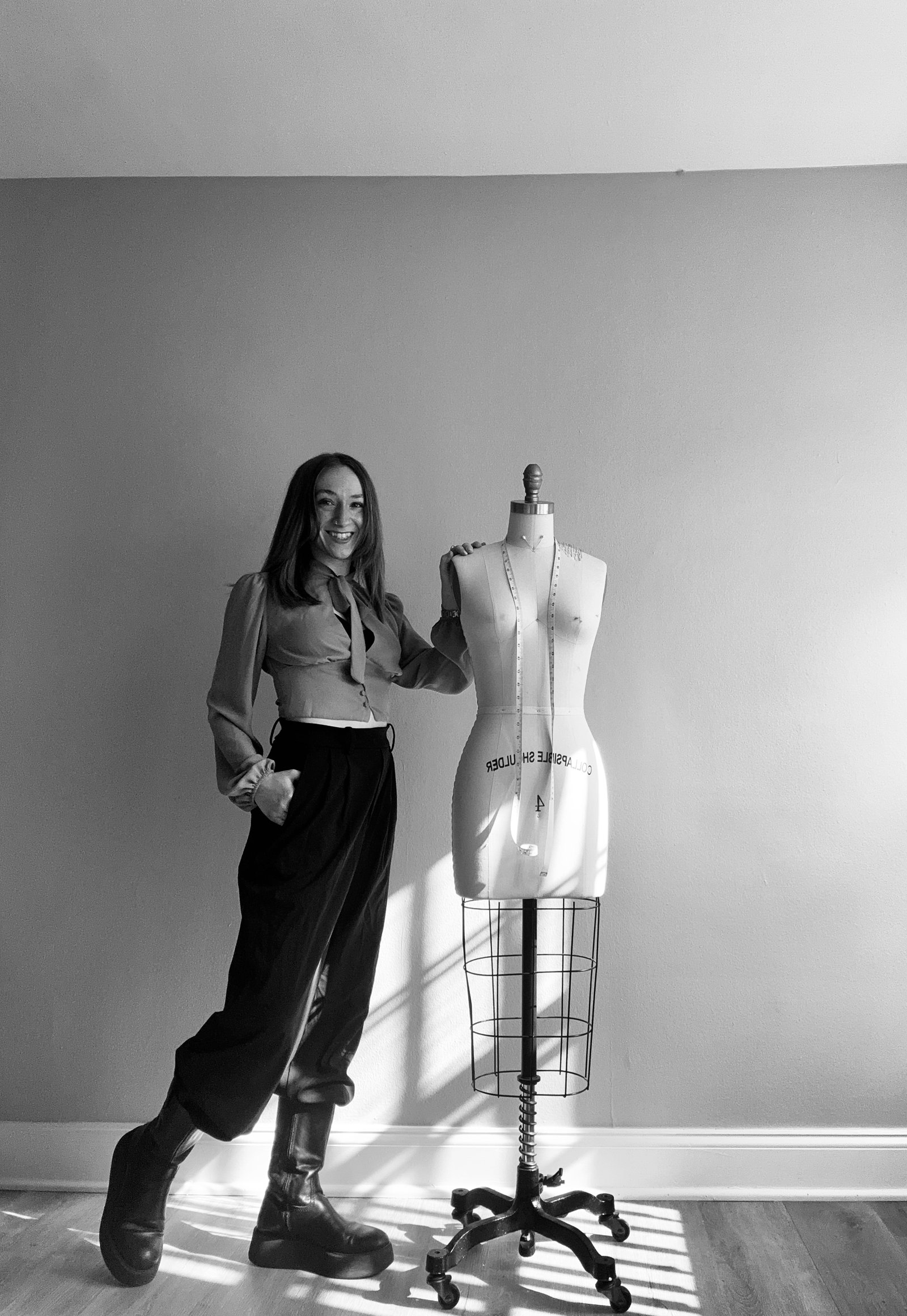 Magen Jae in her atelier beside the dress form &mdash; couture designer at work