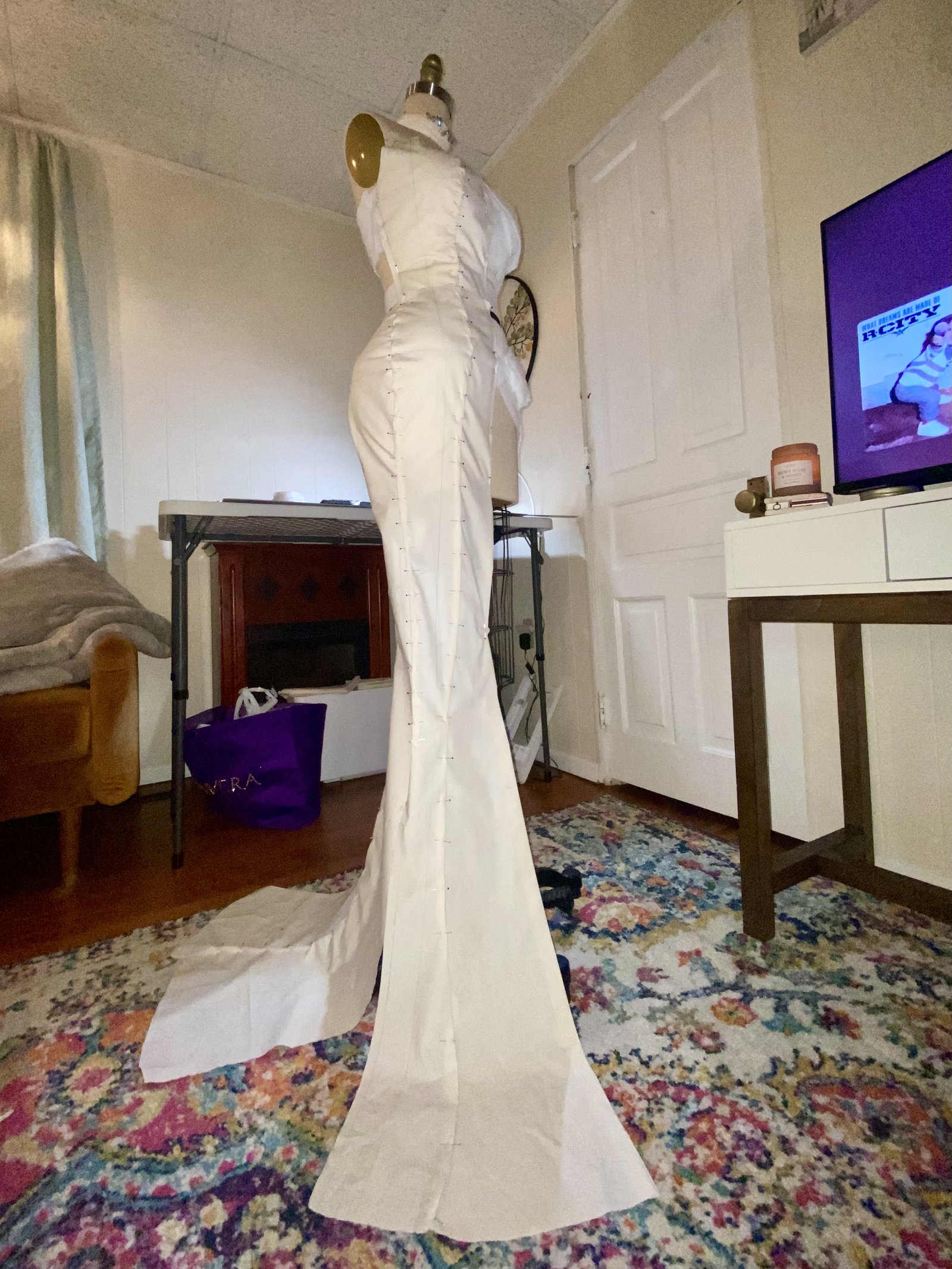 A muslin gown profile pinned on a dress form