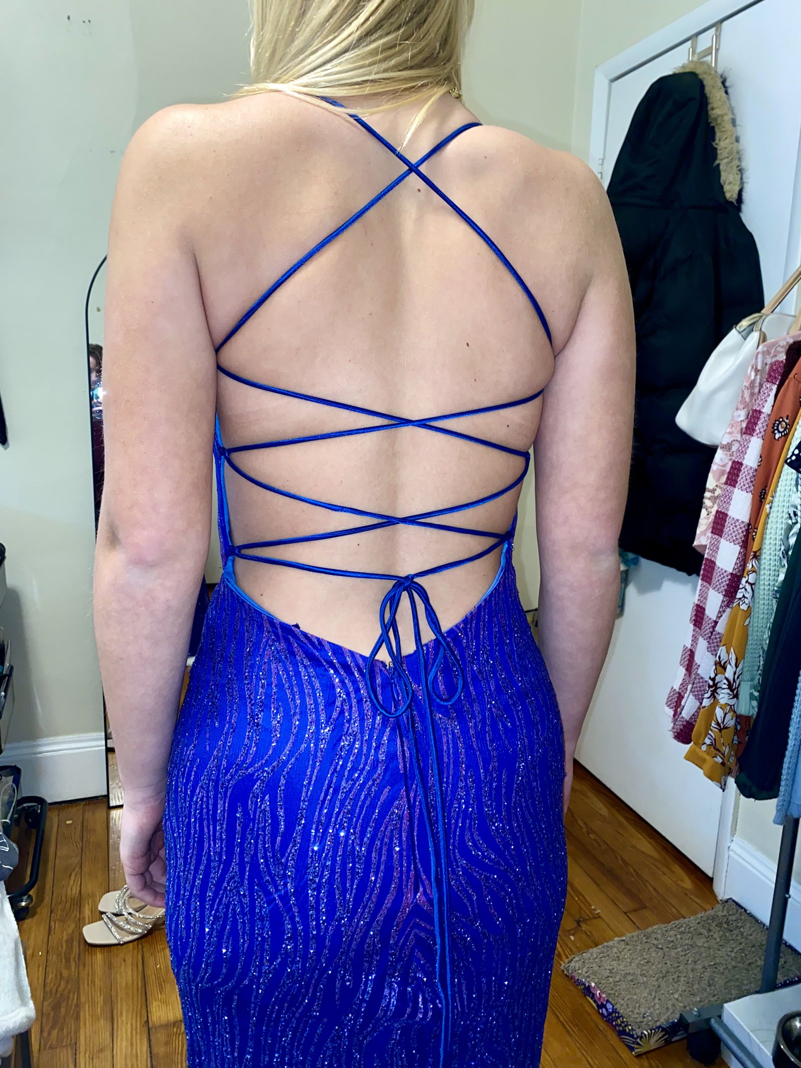 Lace-up back of a royal blue beaded prom gown