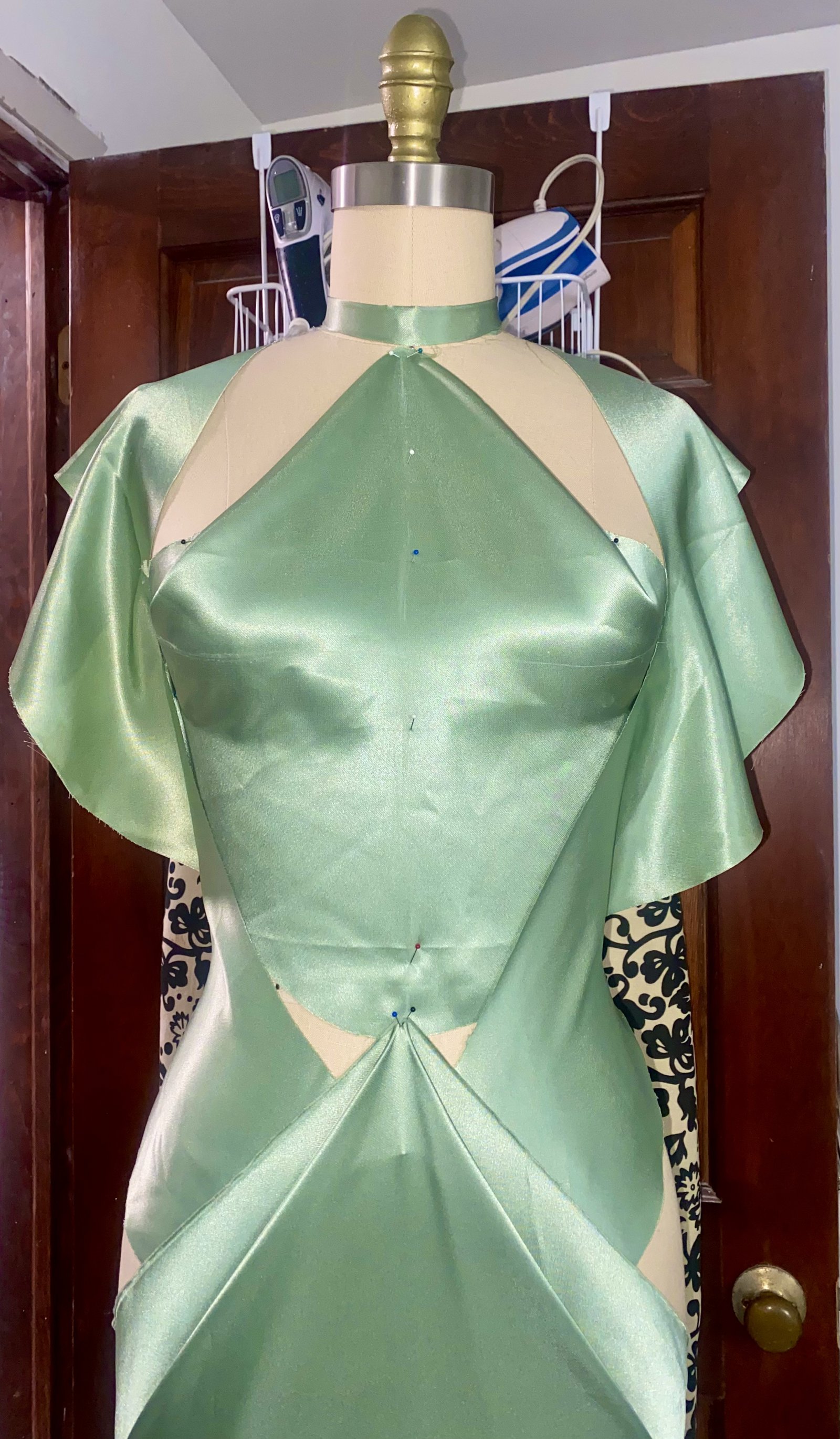 Sage satin couture gown with structured bodice and flutter sleeves